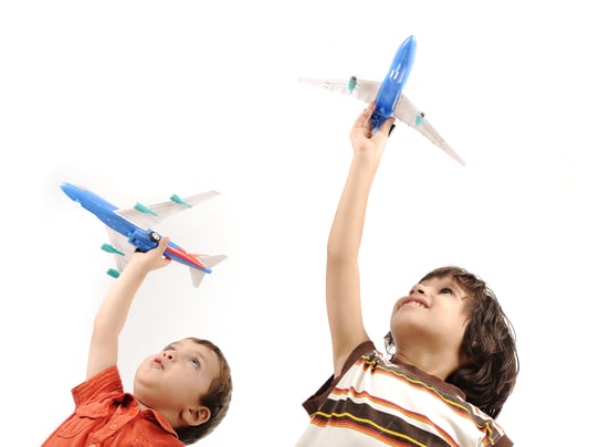 Two boys with airplanes in hands